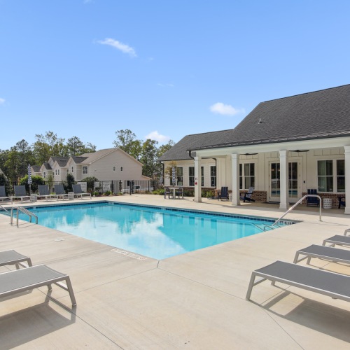 Relax and unwind poolside resort style pool with seating